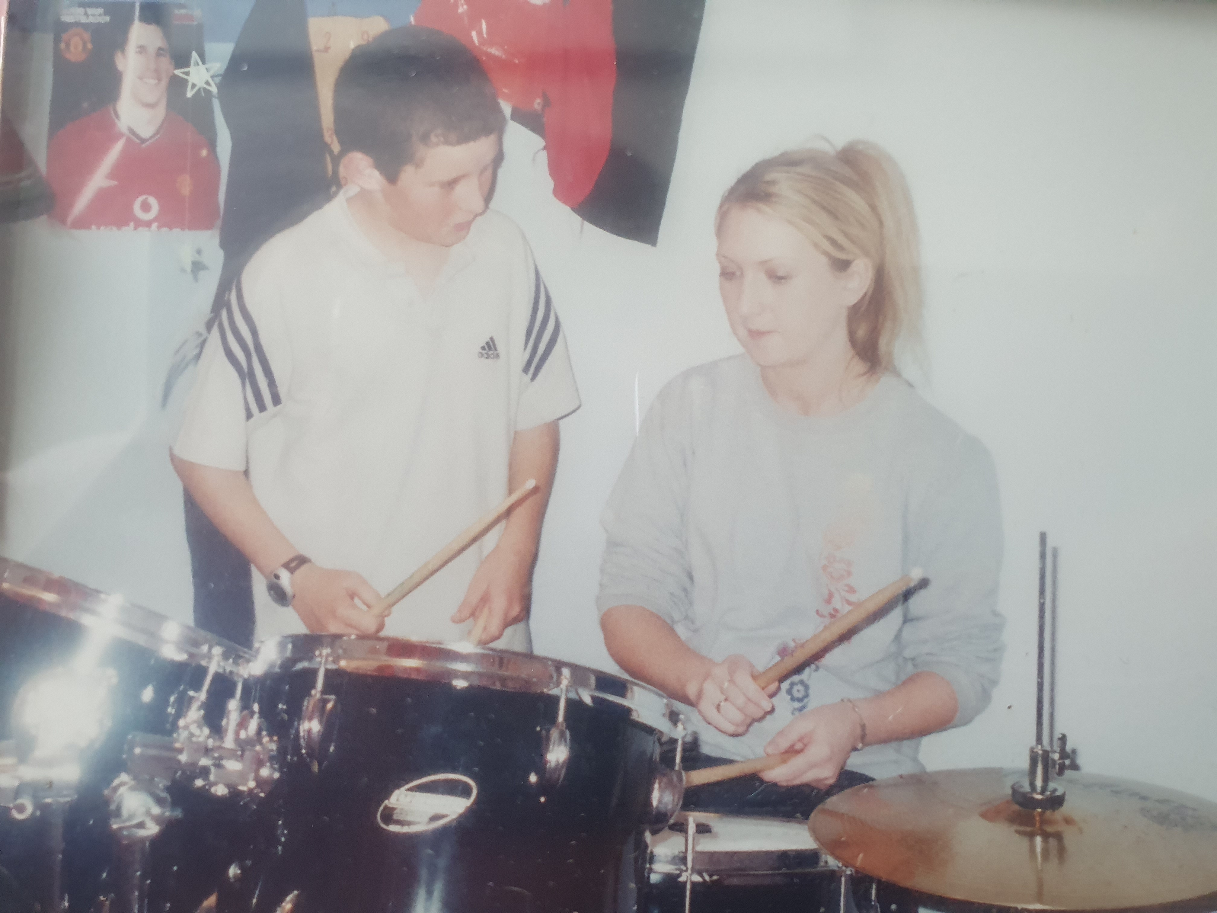 A photo of 12-year-old Cian giving his first drum lesson
